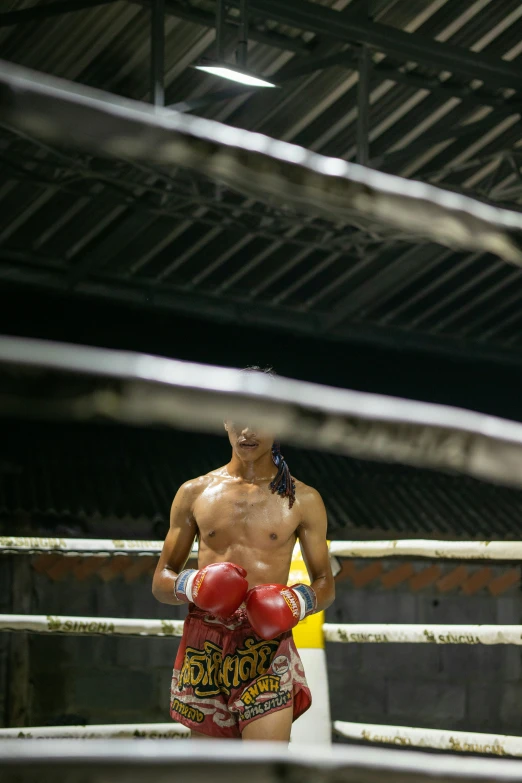 a boxer with his trunks up standing in a boxing ring