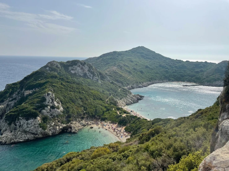 a beach with some mountains in the background