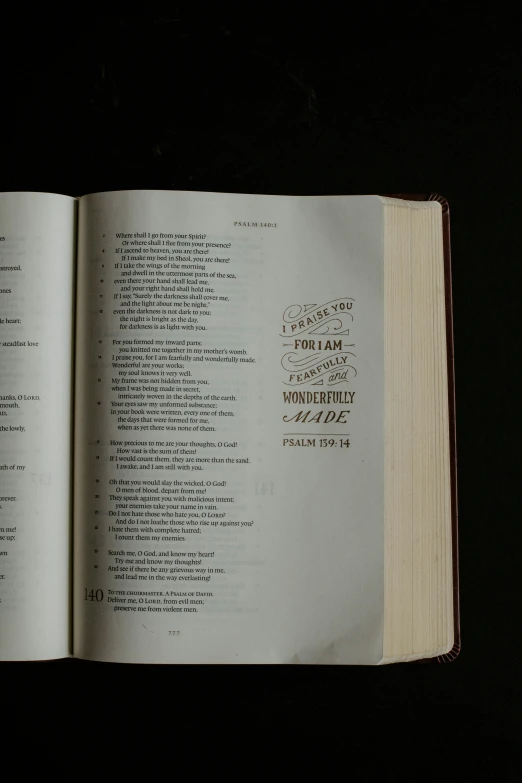a book opened to the bible on a table