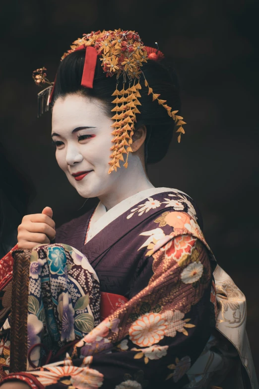 a woman in traditional geisha dress standing near another