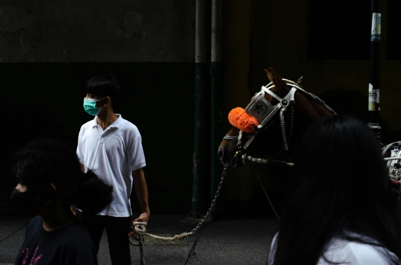 a man walking his horse down a street