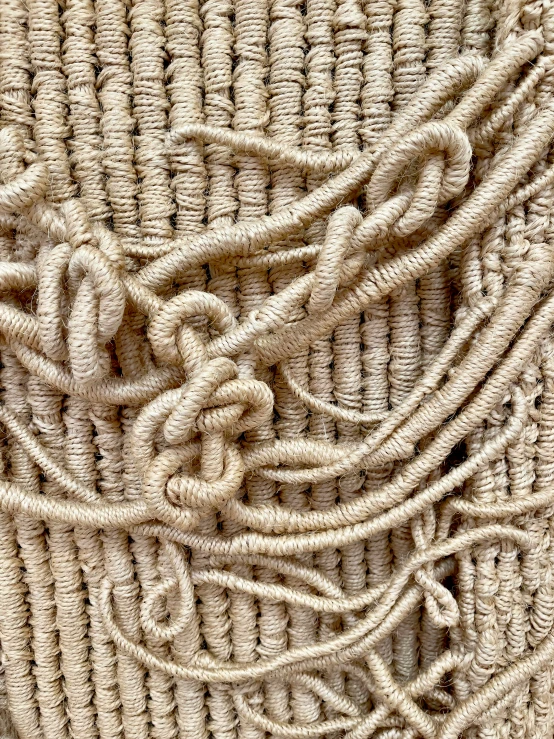 a rope with two ends twisted on a piece of fabric