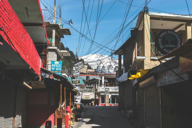 a street with buildings and power lines hanging above