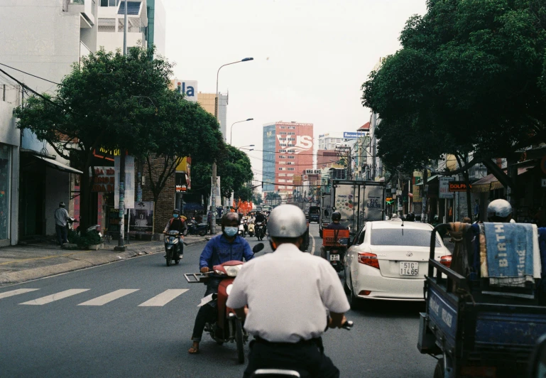 a street filled with traffic and parked cars