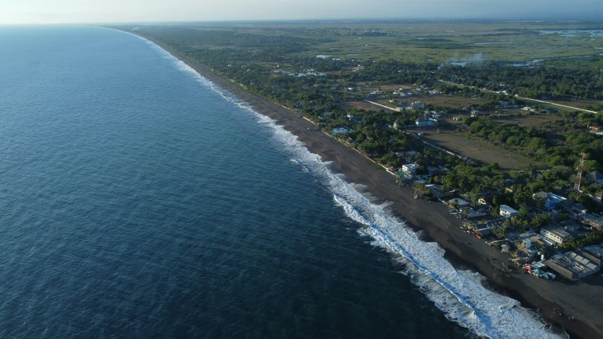 aerial po of ocean with houses in foreground