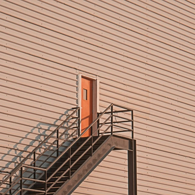 a very big metal handrail next to a building