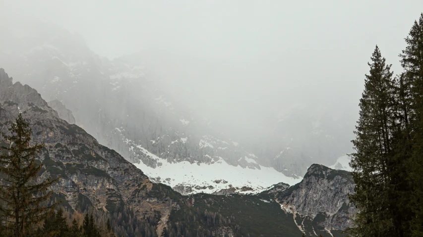 two mountain range covered in snow with trees