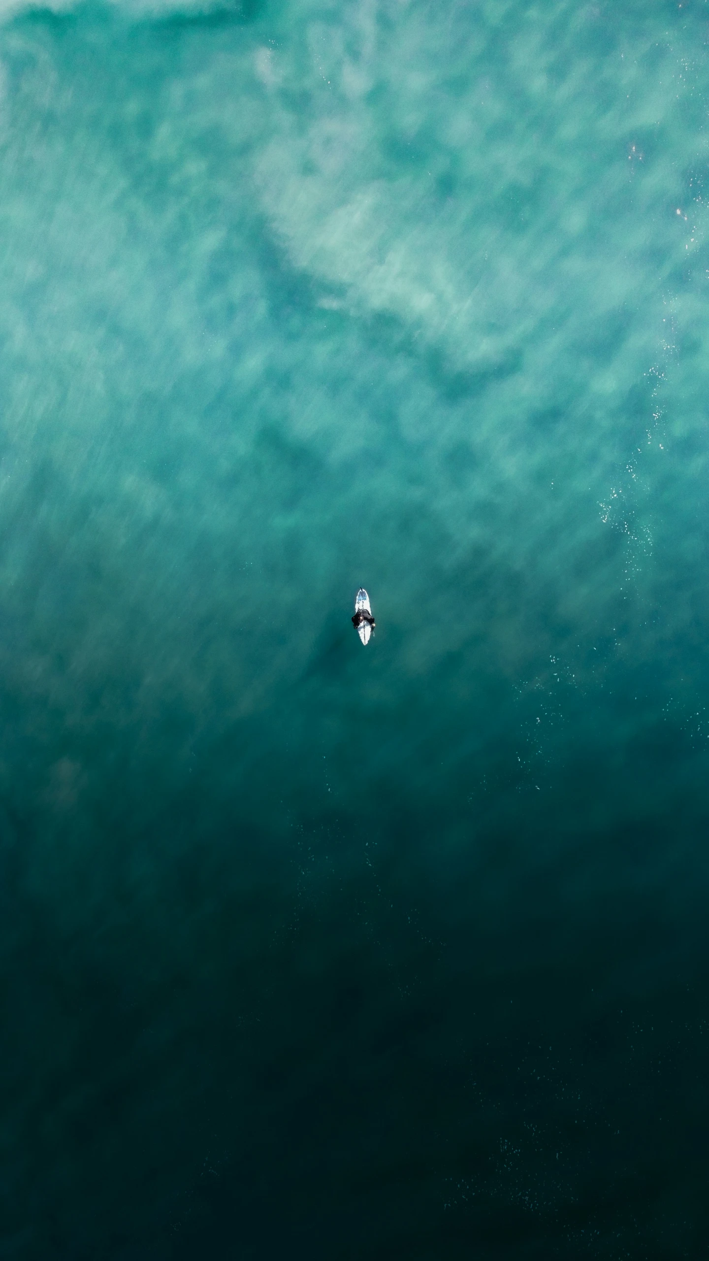 the lone boat is in the middle of the ocean