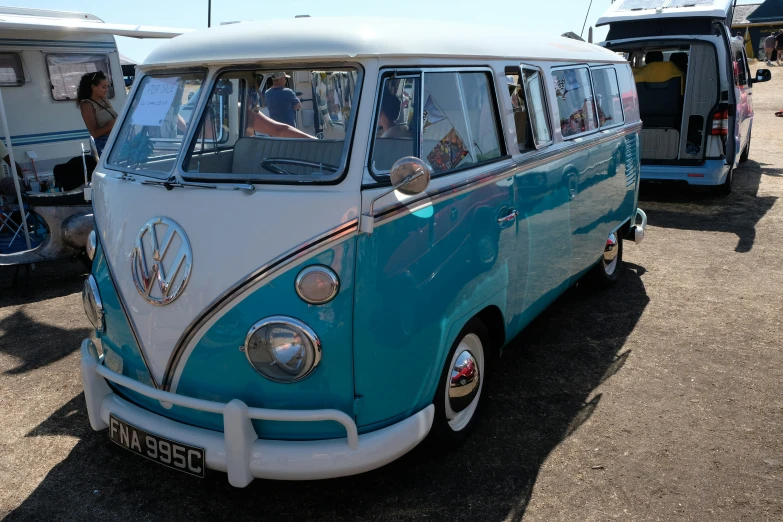 a blue and white vw bus with the door open