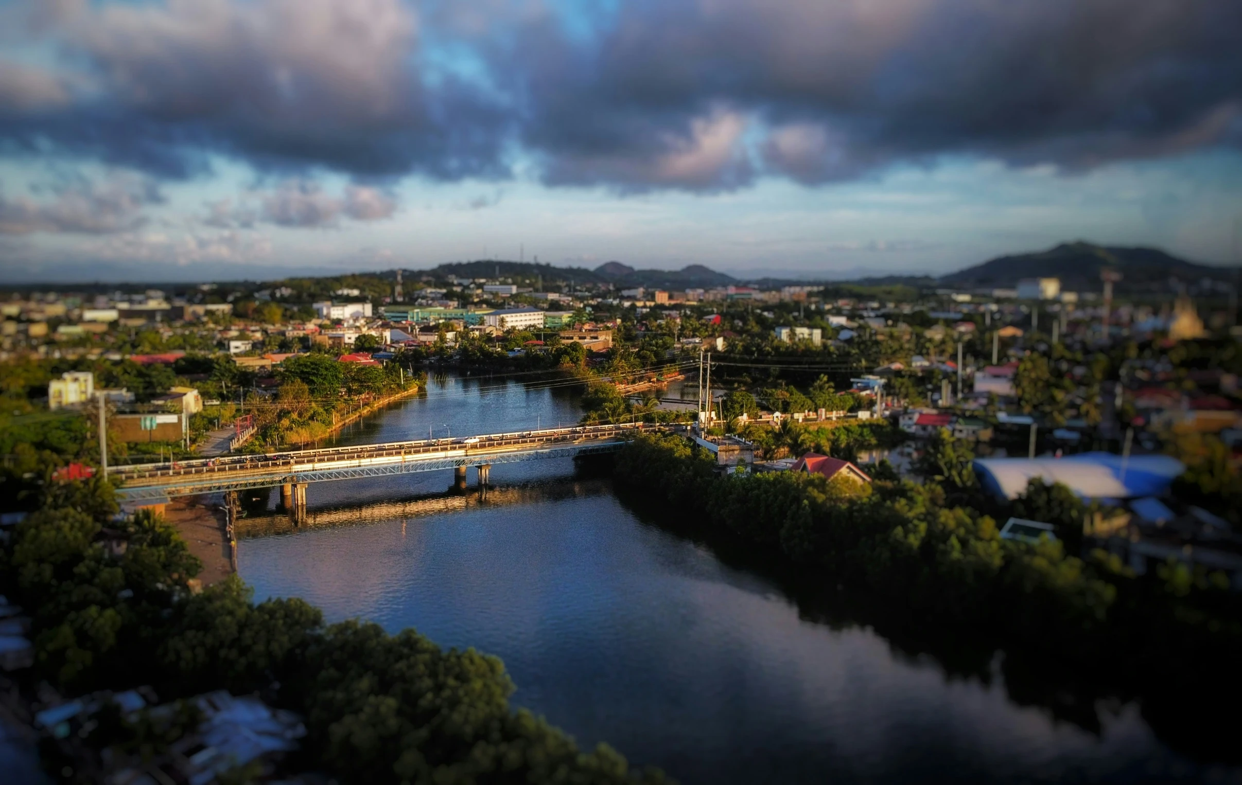 a po taken from above of a river with a bridge