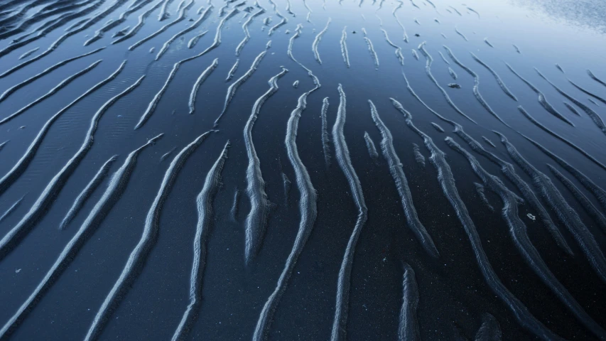 a close up of sand that looks like they are straight lines