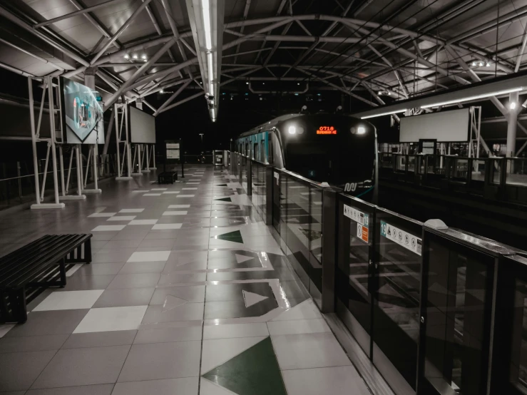 a train station with empty benches and a large window