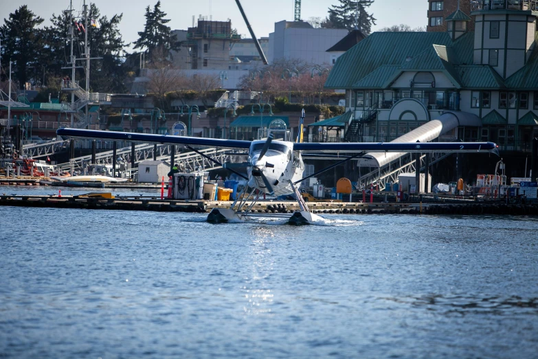 a plane is on a lake and some houses