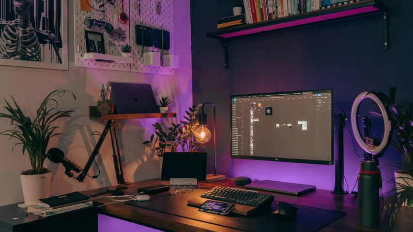 a dimly lit desk with a computer on it