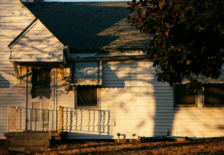 the shadow of a bird perched on a porch