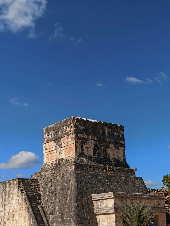 a large building made out of stone under a blue sky