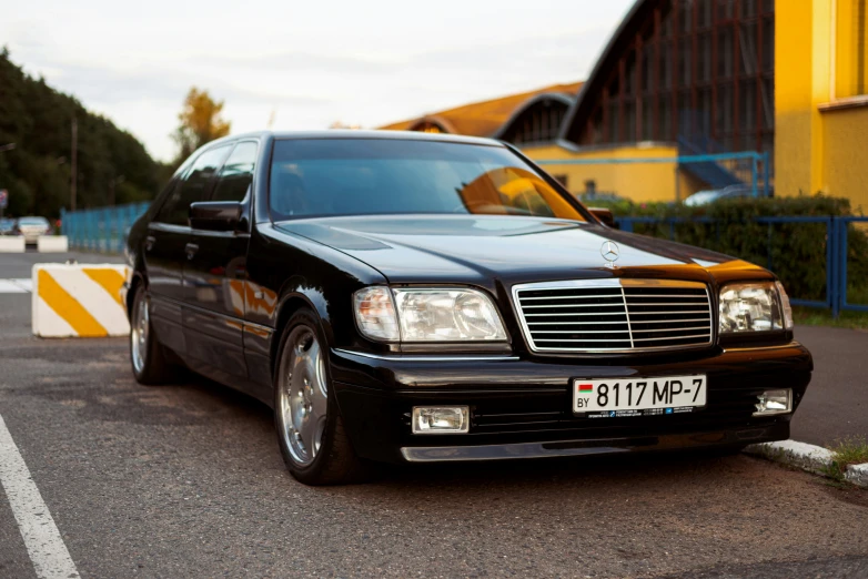 black mercedes benz parked on the side of the road