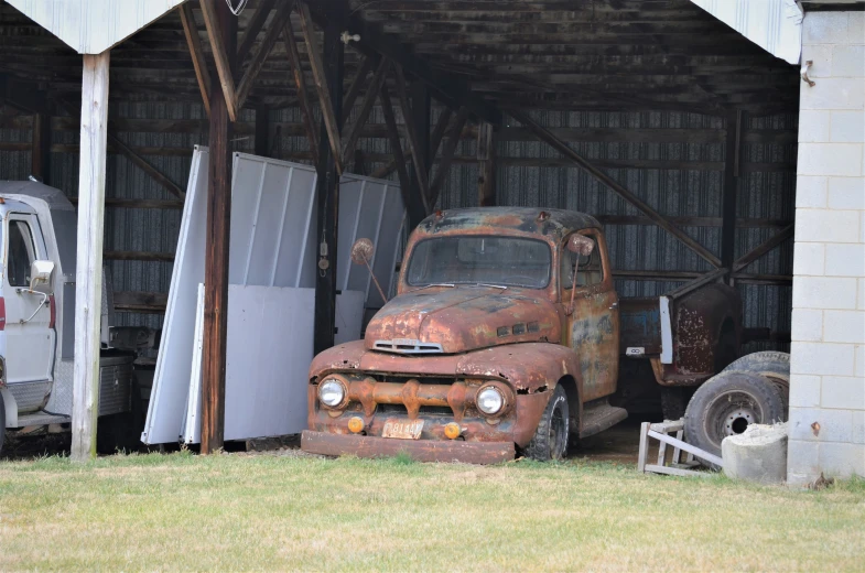 an old, rusted truck sitting in a garage