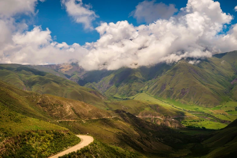 clouds hovering over a scenic area with green trees