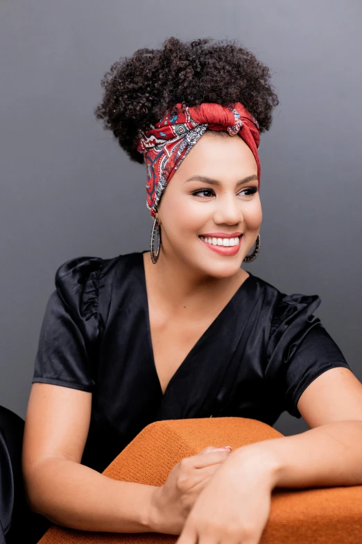 a young african american woman wearing a patterned headband