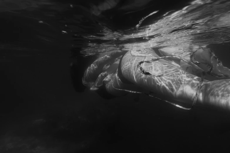 a woman is swimming in the water with a towel over her back