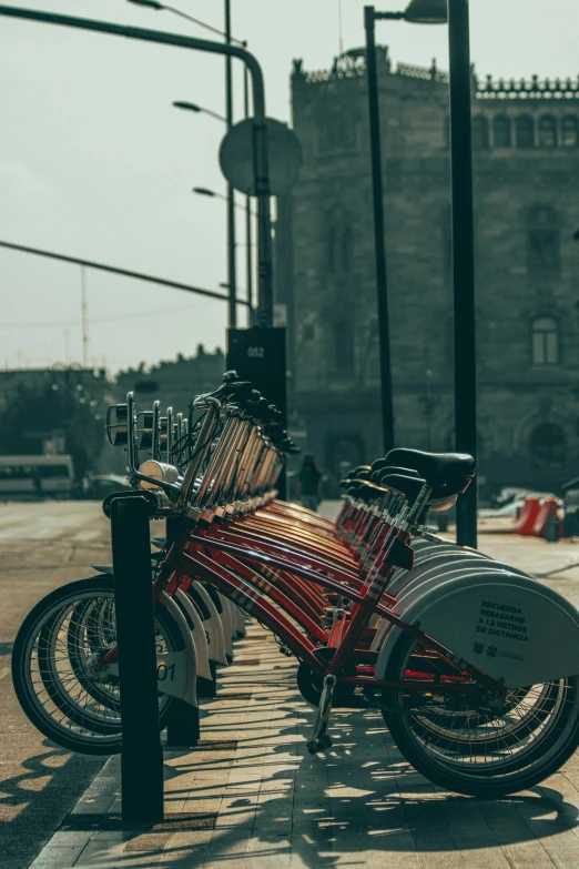 two bicycles that are on a street sidewalk