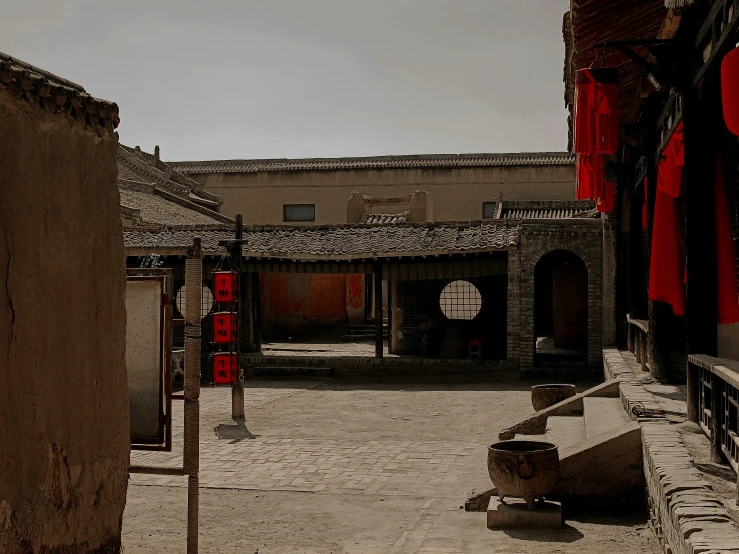 the courtyard of an old chinese courtyard that features a long wall and large pillars