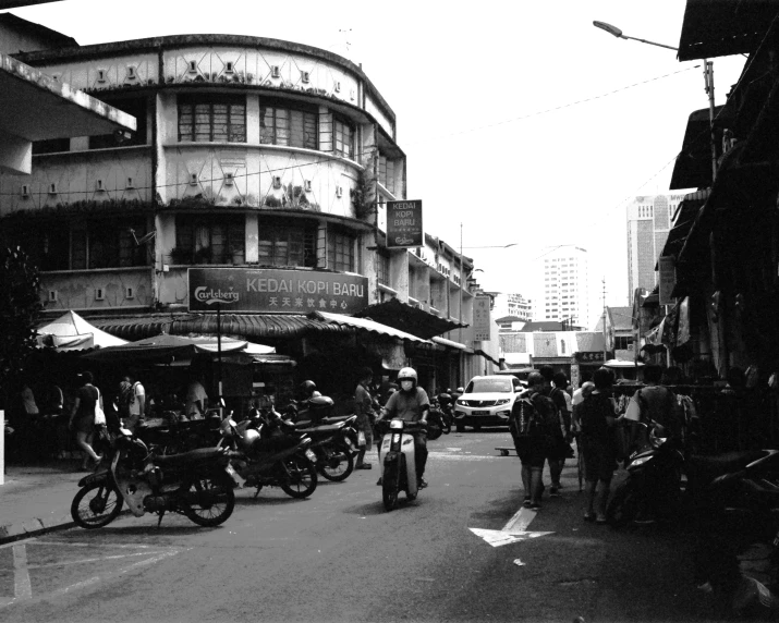 an old pograph of street vendors and bikers