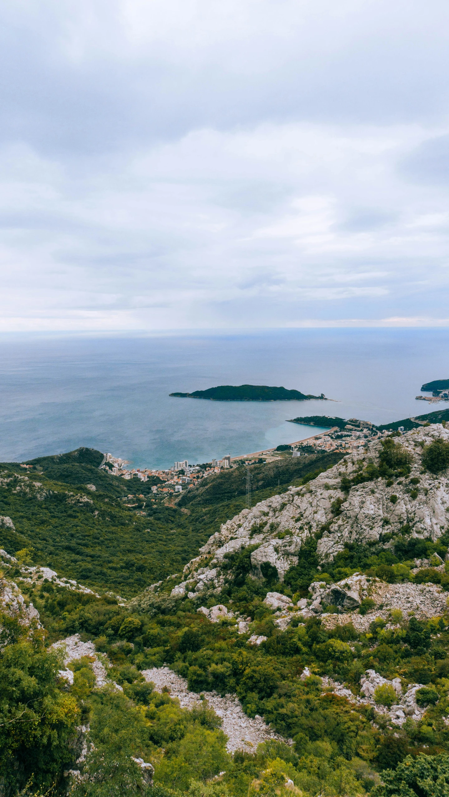 a rocky hill with a large body of water next to it