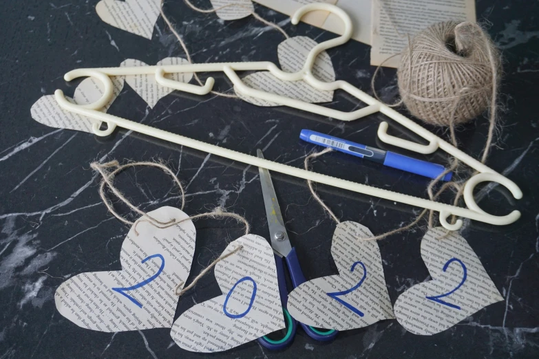 a crafting supplies on a table including scissors and twine of string