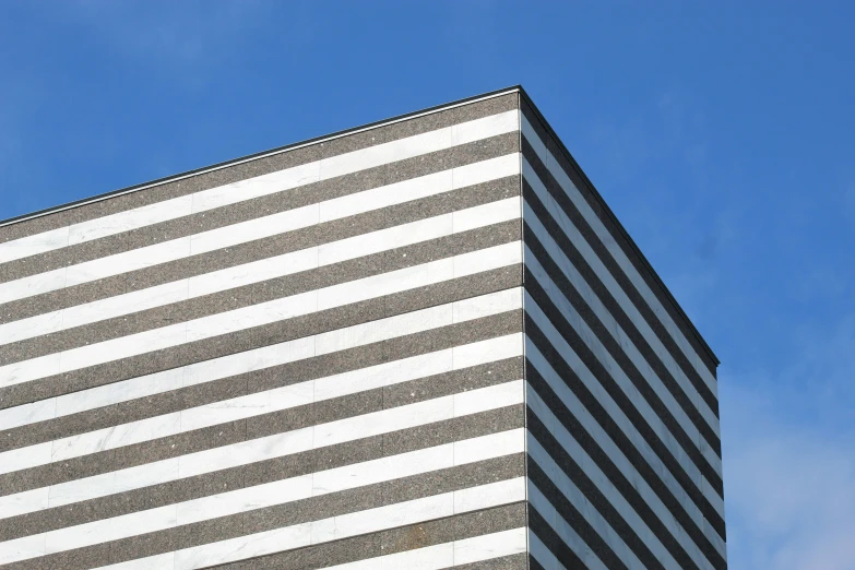 the side of a building with grey and white stripes