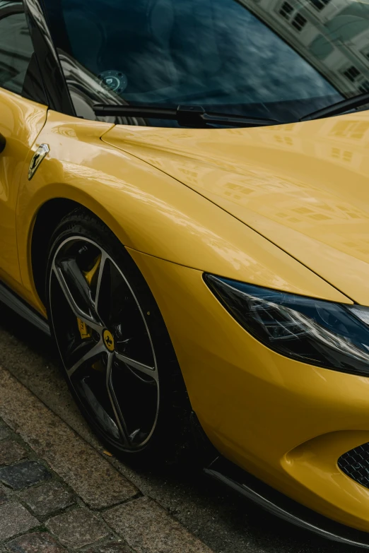 there is a yellow sports car parked in the street