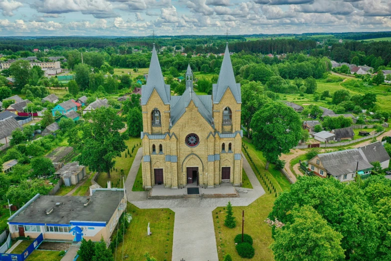 an aerial view of a church with a tall tower