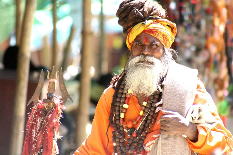 a man with a white beard and wearing a turban