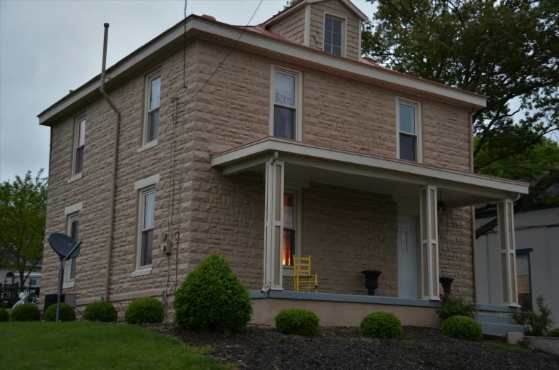 a house with an unusual top story and a turret style on the side