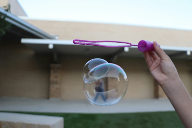 the bubble wand was caught in the air outside the house