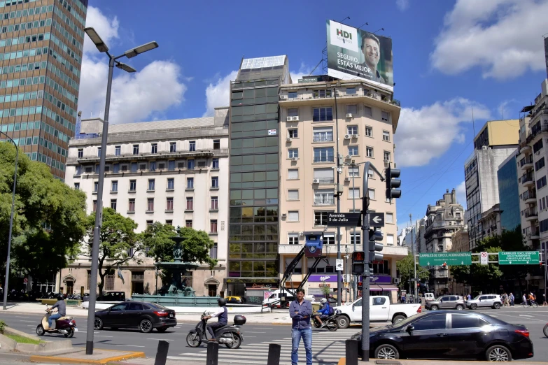 the people stand on the street corner in the city