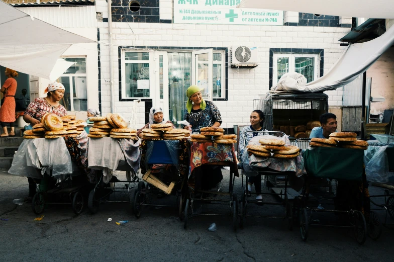 some people are sitting at tables with bread on them