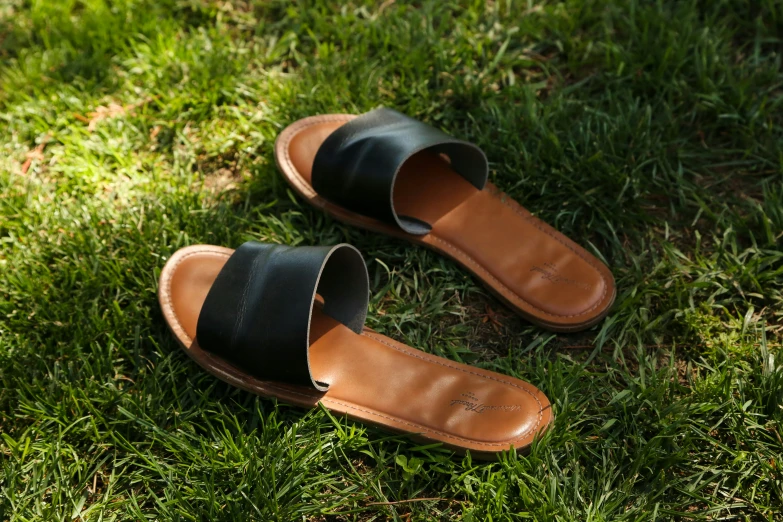 pair of shoes sitting on the ground in grass