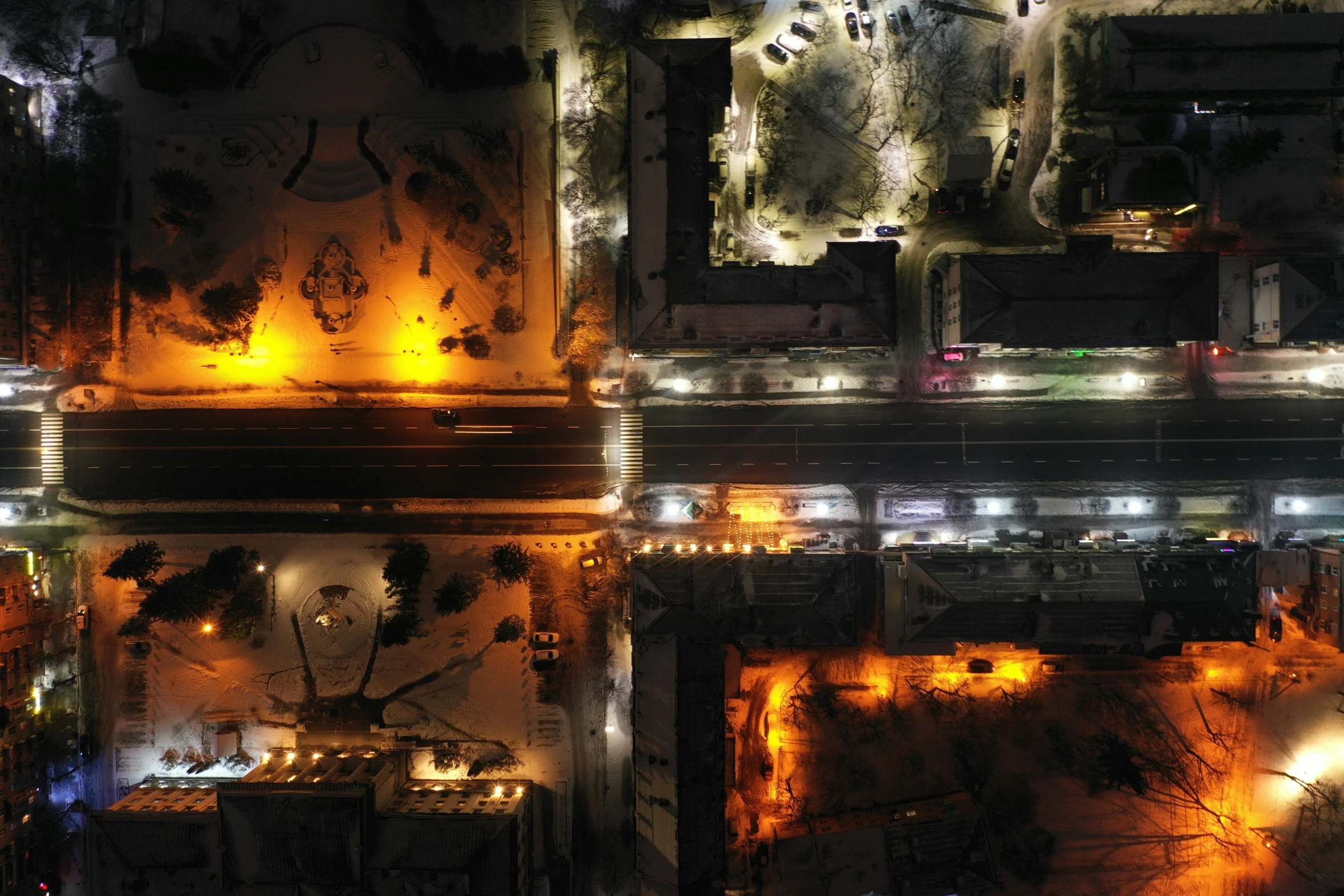 an aerial view of a building and parking lot at night