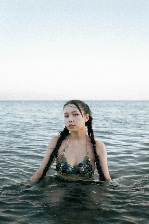 an asian woman wearing ids and in the water