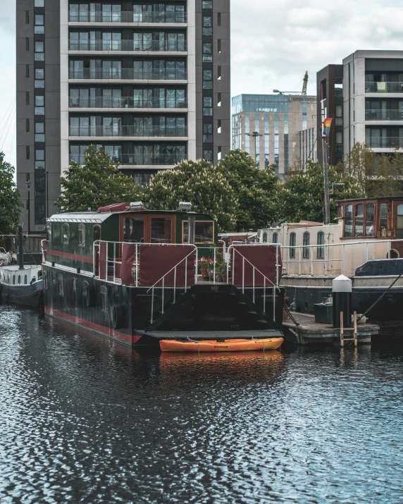 a boat is docked in the water next to a building