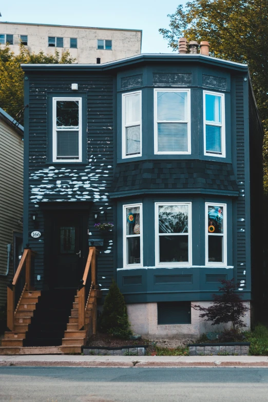 a grey two story house on the corner