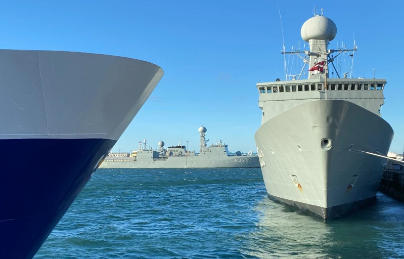 two ships docked next to each other in the water