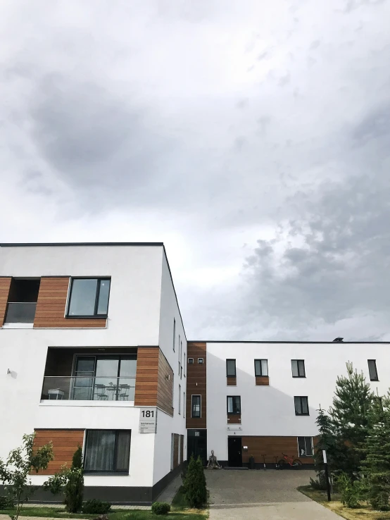 two apartment buildings one has an open driveway