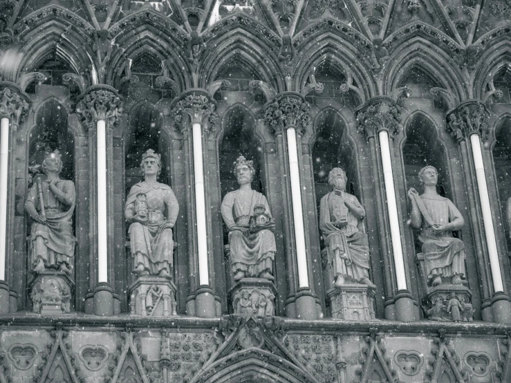 an ornate cathedral with statues of women and men