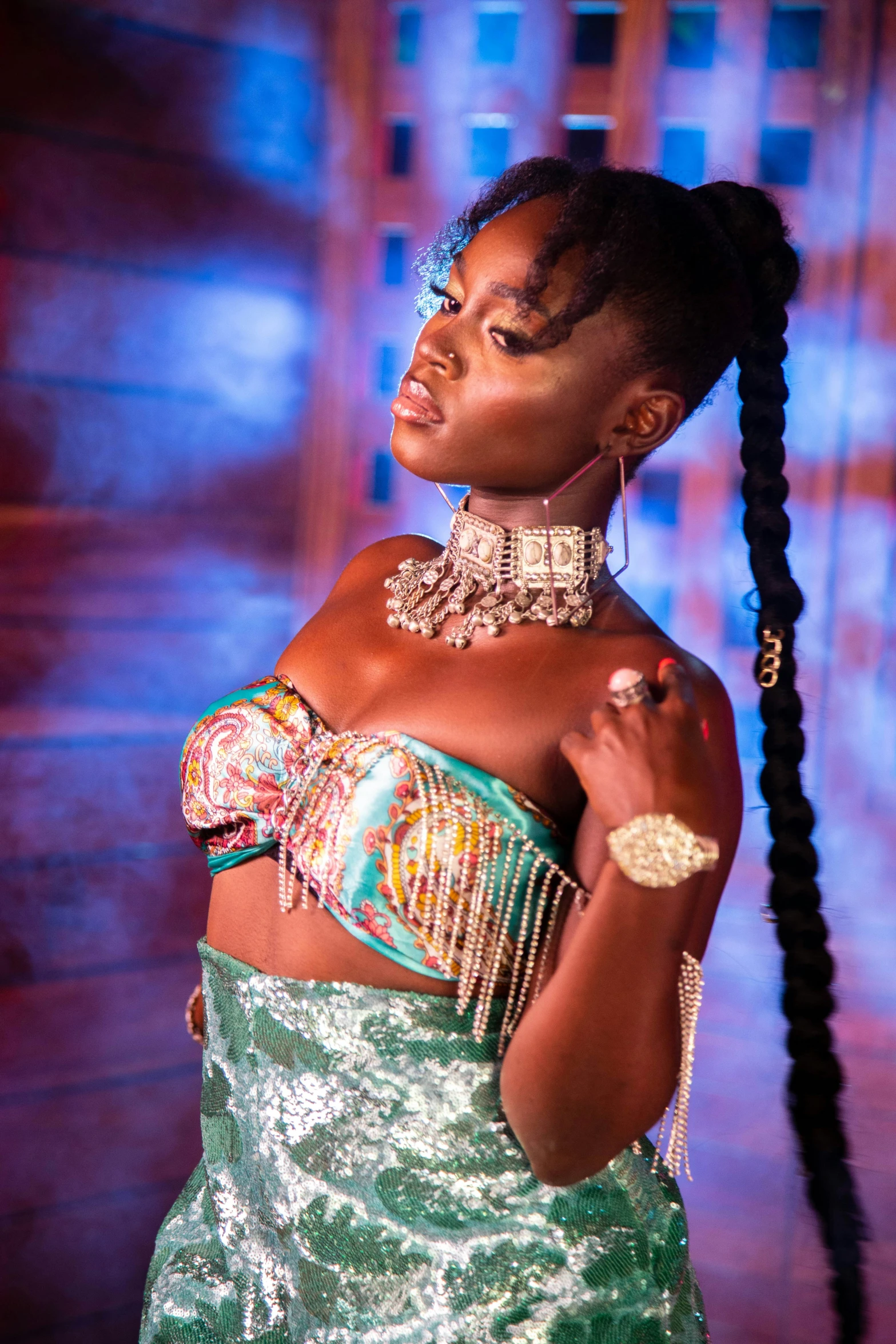 woman in evening dress with a side id in front of a stage backdrop