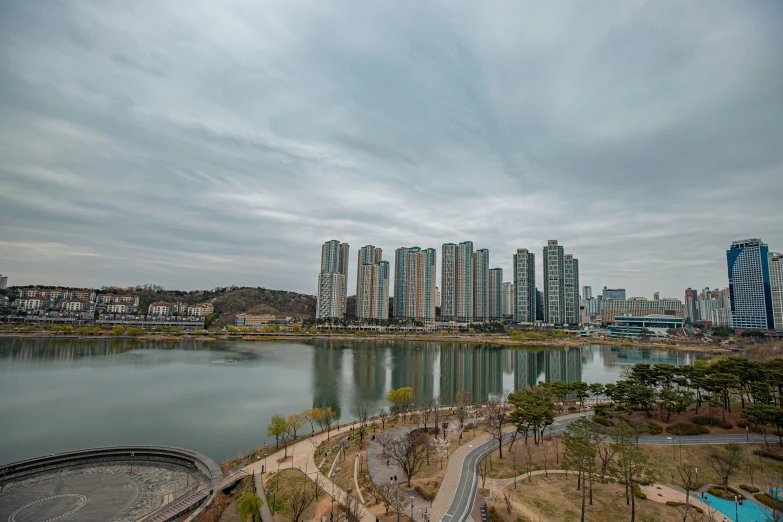 an aerial view of city next to a lake