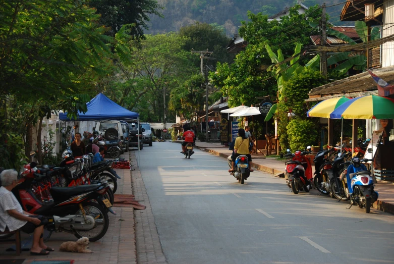 a street lined with motorcycles and tents lined up on the sides