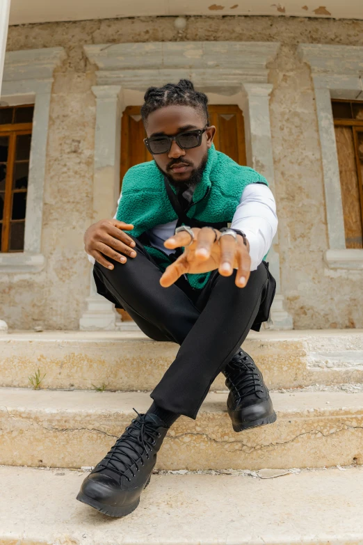 a man sitting on the steps holding a stuffed animal